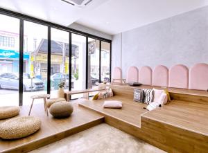 a room with a bench and chairs in a store at One Heritage Hotel in Seremban +60 photos