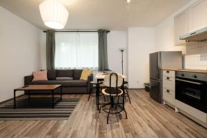 a kitchen and living room with a couch and a table at Periva Apartment Zagreb in Zagreb
