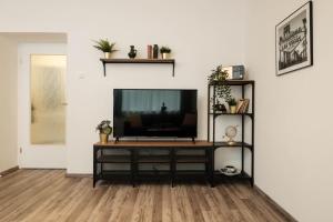 a living room with a flat screen tv on a entertainment center at Periva Apartment Zagreb in Zagreb
