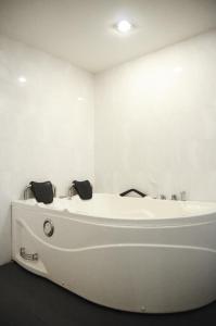 a white bath tub in a white room at NEWLAND HOTEL in Johor Bahru