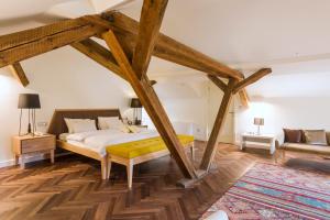 a bedroom with a bed and a wooden floor at Hotel Gradska Cetinje in Cetinje