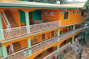 eine Luftansicht auf ein orangenes Gebäude mit Balkonen in der Unterkunft La Solana Suites and Resorts by Cocotel in Puerto Galera