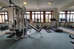 a gym with several tread machines in a room at Rosat 13 in Chateau-d'Oex