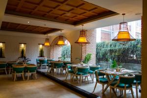 a dining room with tables and chairs and lights at Arushi Boutique Hotel in Kathmandu