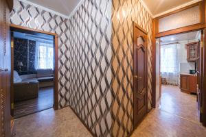 a hallway with a door and a living room at Apartments on Karla Marksa in Mogilev