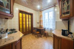 a kitchen with a sink and a table at Apartments on Karla Marksa in Mogilev