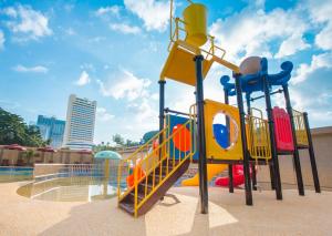 a playground with a slide in a park at Ibis Melaka in Melaka