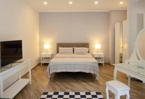 サレルノにあるFronte Del Portoのベッドルーム1室(ベッド1台、テーブル2台、テレビ付)