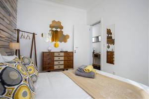 - une chambre avec un grand lit et une tête de lit en bois dans l'établissement Sunny Apartment in a typical Lisbon neighborhood, à Lisbonne