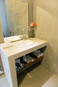een badkamer met een wastafel en een spiegel bij The Ocean Residence Langkawi in Kuah