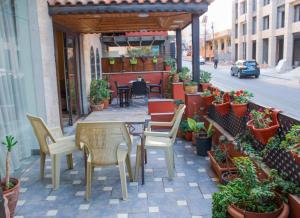 
a patio area with chairs, tables, and tables with umbrellas at Rumman Hotel in Madaba
