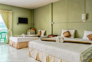 a hotel room with two beds and a tv at Hotel Kata Hill Sea View in Kata Beach +37 photos