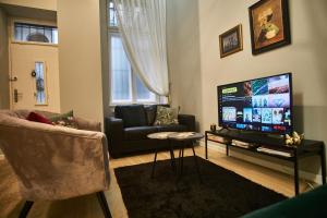 a living room with a couch and a flat screen tv at K95 Apartment - Budapest in Budapest