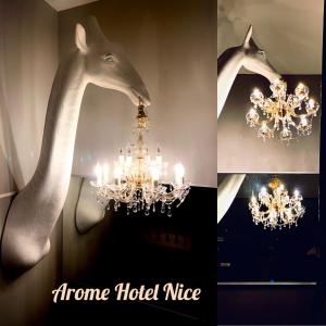 a picture of a chandelier with a giraffe head on the wall at Arome Hotel in Nice