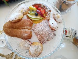 a plate of pastries and bread on a table at Il colore dei sogni in Due Carrare