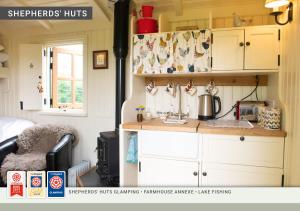 a kitchen in a tiny house with a counter top at Morndyke Shepherds Huts in Thirsk