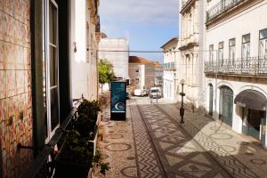 an empty street in a city with buildings at Family House in Aveiro
