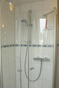 a shower with a glass door in a bathroom at Haus Petersen in Undeloh