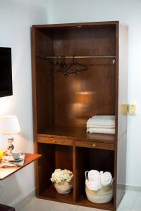 a wooden hutch with towels in a room at Beulah Hotel Boutique in Asuncion