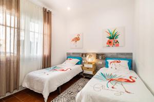 A bed or beds in a room at CASA FLAMINGO