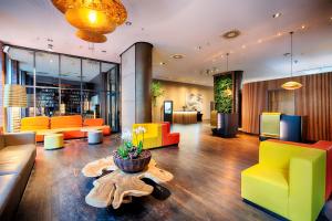 a lobby with colorful furniture and a table at ACHAT Hotel Bremen City in Bremen