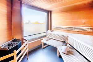a sauna with two benches and a large window at ACHAT Hotel Bremen City in Bremen