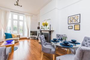 a living room with a table and chairs at All On Your Doorstep in Portsmouth