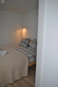 1 dormitorio con 1 cama en una habitación blanca en Klein Garnwerd 9, en Garnwerd