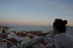 a woman is looking out over a city at Casa Do Canto in Albufeira
