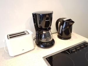 a blender and a toaster sitting on a counter at Three Bedroom Marble Apartment in the Heart of Antwerp in Antwerp