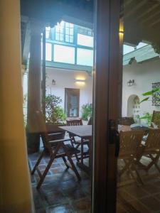 an open door to a patio with a table and chairs at El Patio del Convento in Toledo
