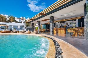 a swimming pool in the middle of a house at San Marino Suites by Calm Collection in Fira