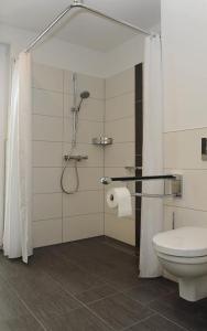 a bathroom with a shower and a toilet in it at Hotel Am Markt in Heek