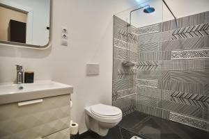 a bathroom with a toilet and a sink and a shower at K95 Apartment - Budapest in Budapest