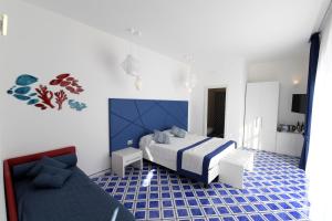 a bedroom with a bed and a couch at Palazzo San Giovanni Amalfi Coast in Scala +75 photos