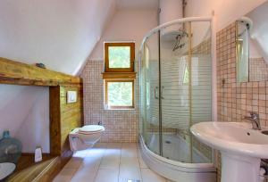 a bathroom with a tub and a sink and a toilet at Herzegovina Lodges Boracko Jezero in Konjic +120 photos