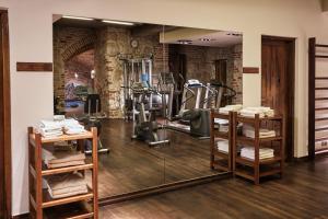 a gym with a mirror and some exercise equipment at Hotel Stary in Kraków