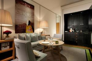 a living room with a couch and a table at Portrait Roma - Lungarno Collection in Rome
