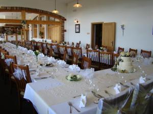 a long table with a wedding cake on top of it at Hotel Podlesí in Podlesí