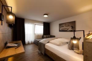 Postel nebo postele na pokoji v ubytování Hotel Brugger