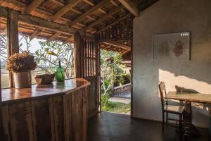 a kitchen with a counter and a table in a room at The Artist Cottages in Morjim