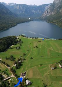 an aerial view of a golf course next to a lake at Apartments Kovačič in Bohinj