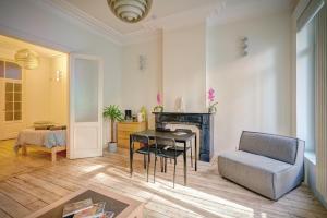 a living room with a table and a chair at The Greenplace Lodge. Apartment in Heart of Antwerp. in Antwerp