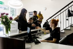 a woman sitting at a desk in an office at dask resort in Szklarska Poręba