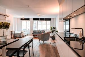 a kitchen and living room with a table and chairs at Light House Lodge. Apartment in Center of Antwerp in Antwerp