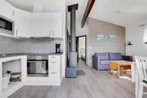 a kitchen and living room with a couch and a table at Fide Äventyrsby & Camping in Fidenäs