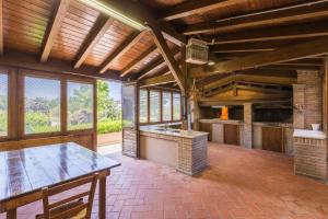 a large room with a table and a fireplace at Villa delle Rose in Montalto delle Marche