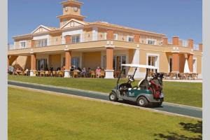 a golf cart parked in front of a large building at Luxury apartment with free use of pool, gym and spa in Lagos