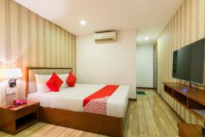 a bedroom with a bed and a flat screen tv at Hung Phat Hotel - Trung Son in Ho Chi Minh City