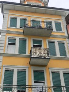 a building with a balcony with green shutters at central beauty scenery apartment in Interlaken